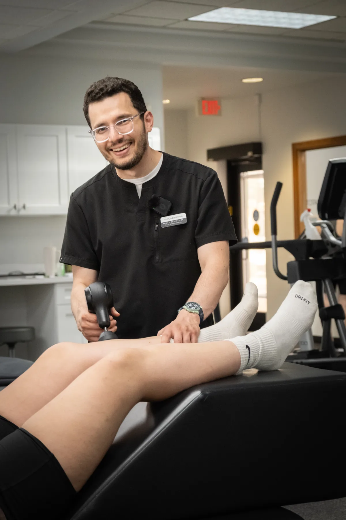 Ahmad Alaiwat, DPT, OMPT, treating a patient at Total Body Rehab